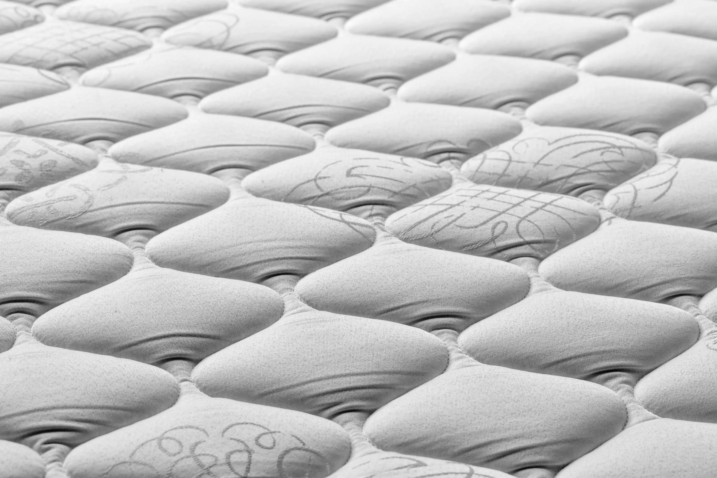 Close-up of a white quilted mattress